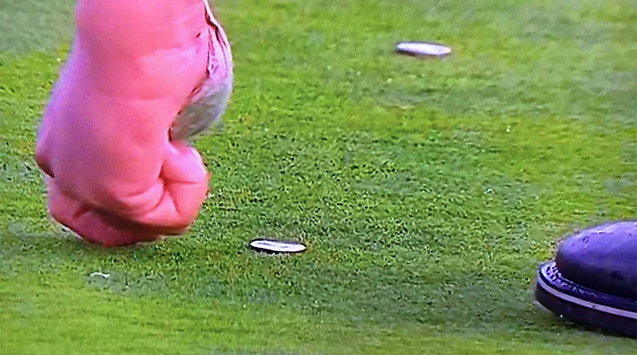 Phil Mickelson marks his ball during Sunday's round at Pebble Beach.