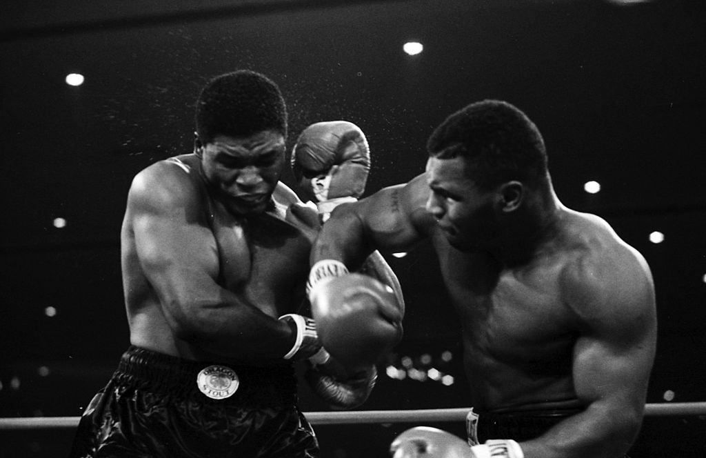 LAS VEGAS - NOVEMBER 22,1986: Mike Tyson (R) connects with a right hook against Trevor Berbick during the bout at Las Vegas Hilton on November 22, 1986 in Las Vegas, Nevada. Mike Tyson won the WBC heavyweight title. (Photo by The Ring Magazine via Getty Images)