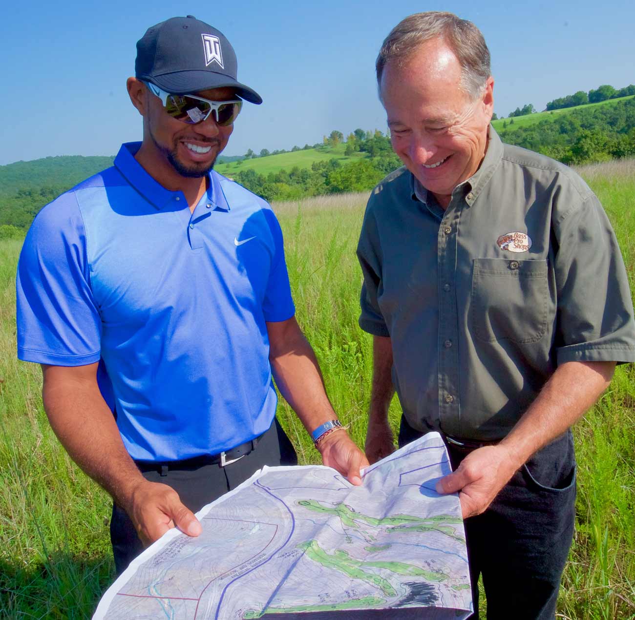 Tiger Woods and Big Cedar Lodge owner Johnny Morris look over a course blueprint.