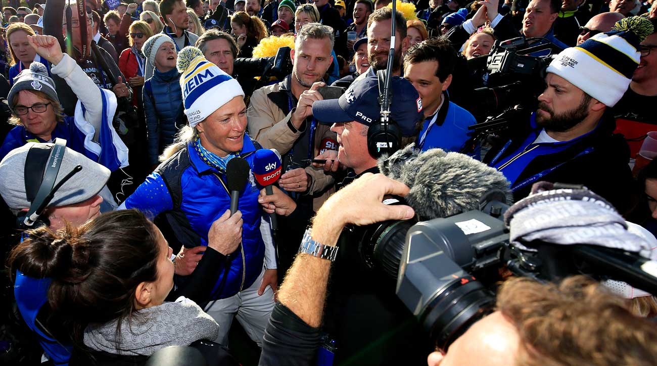 Suzann Pettersen surrounded by reporters at the Solheim Cup as she announces her retirement from pro golf.