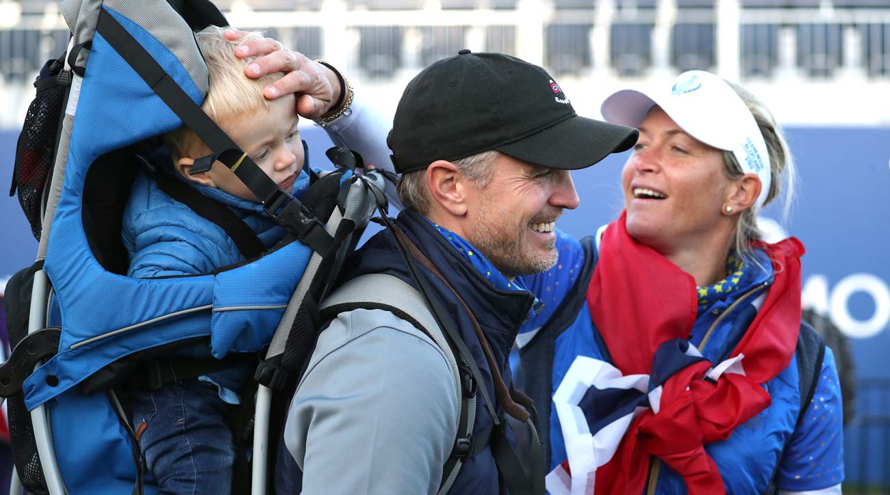 Suzzan Pettersen greets her son, Herman, and husband, Christian, following her dramatic Solheim Cup victory.