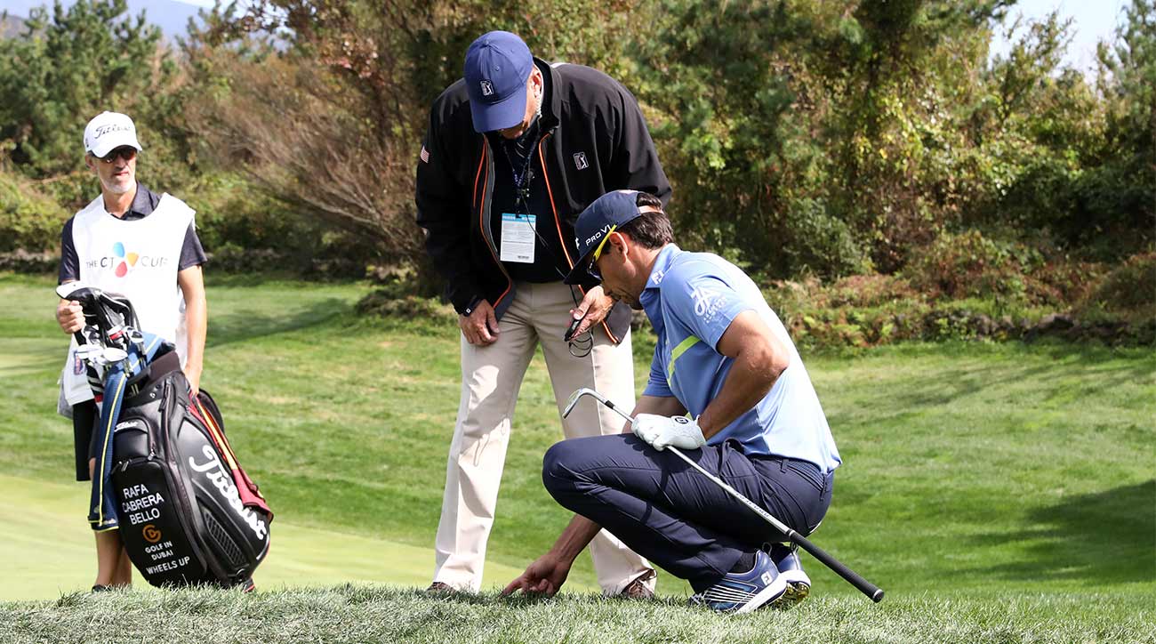 Rafa Cabrera-Bello speaks to a rules official.