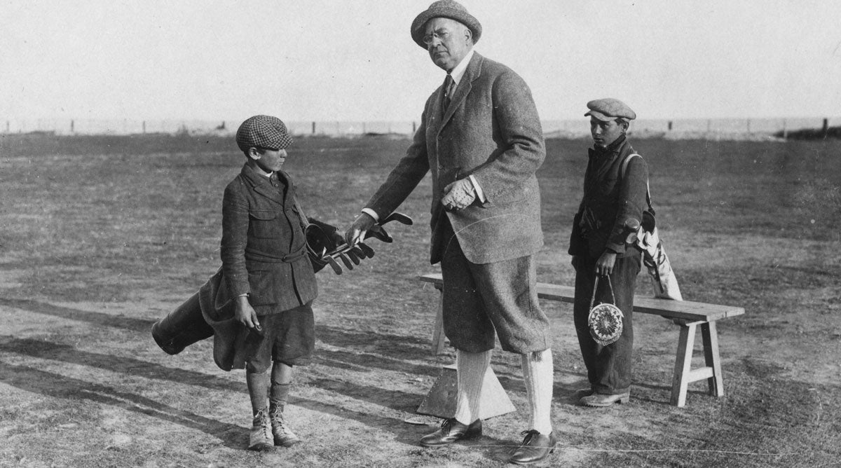 A golfer and his bagman — well, bagboy — circa 1922.