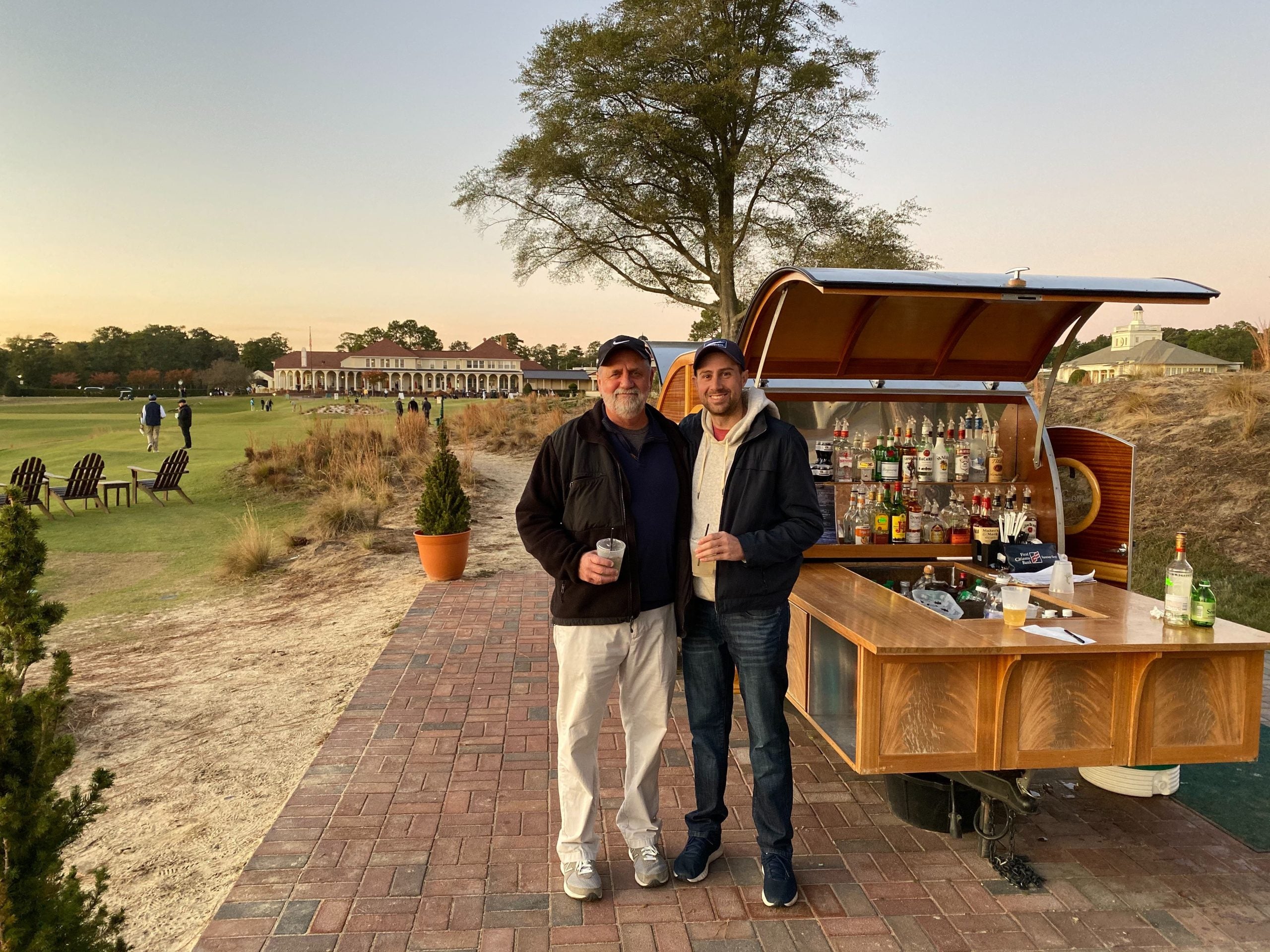 My dad and I enjoying a drink at The Cradle's mobile bar to end a Pinehurst golf trip