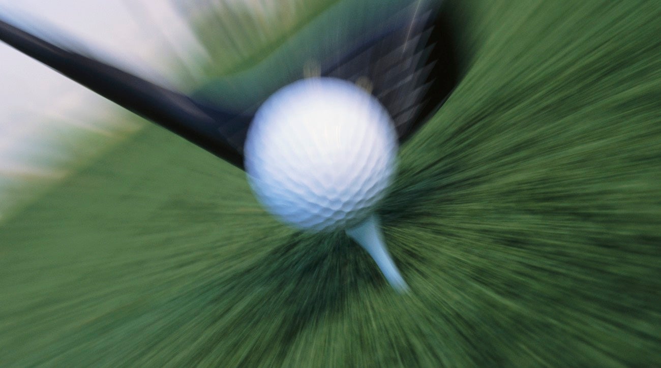 A clubhead hitting a golf ball at high speed