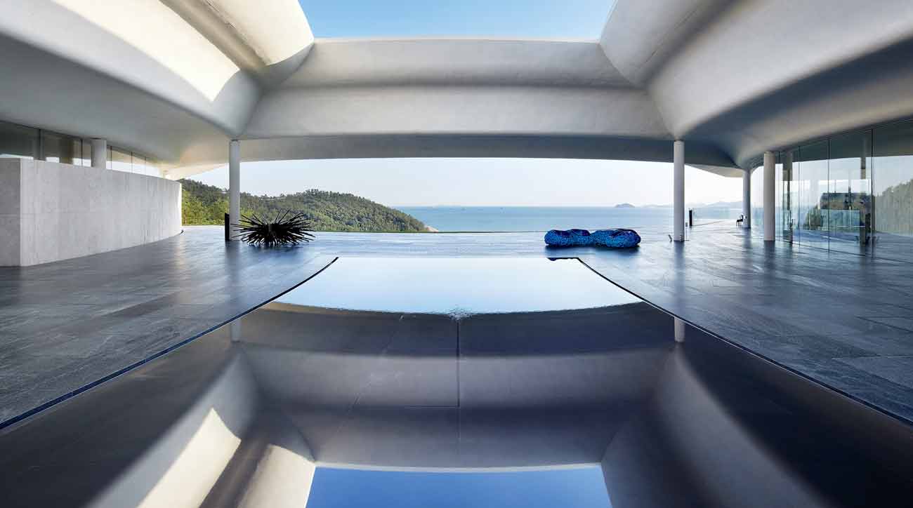 The resort&rsquo;s entrance features an open roof, reflecting pool and gorgeously framed view of the South Sea.