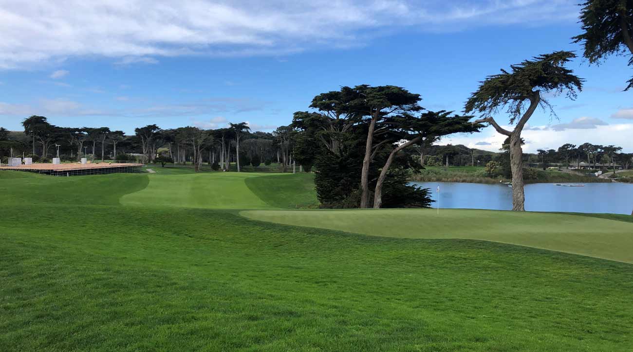 An empty fairway at Harding Park with PGA Championship infrastructure in the background.