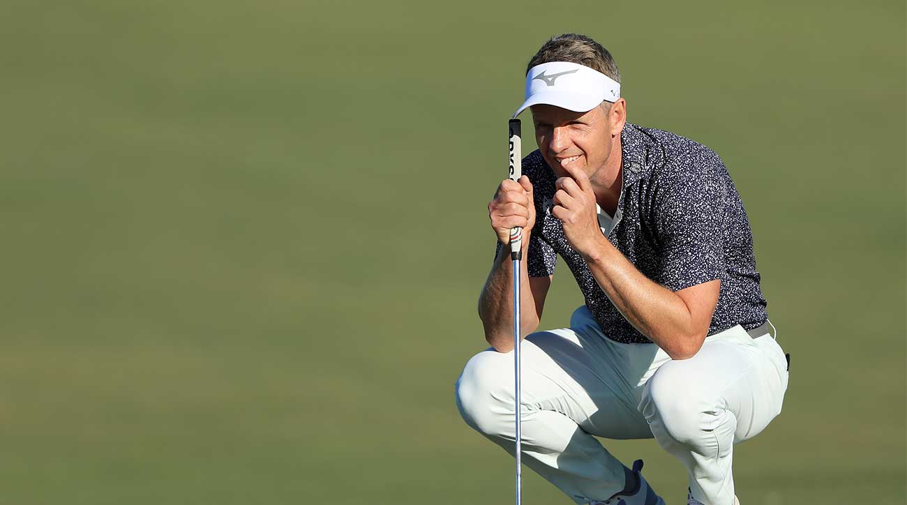 Luke Donald crouches putt