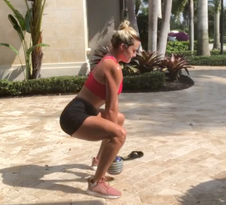 The first move in Lexi Thompson's at-home workout is a squat. 