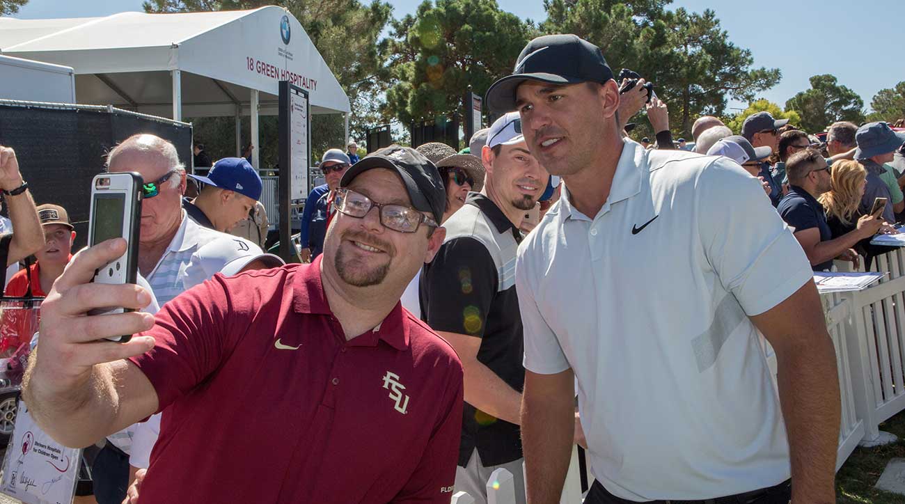 Brooks Koepka takes a selfie with a fan