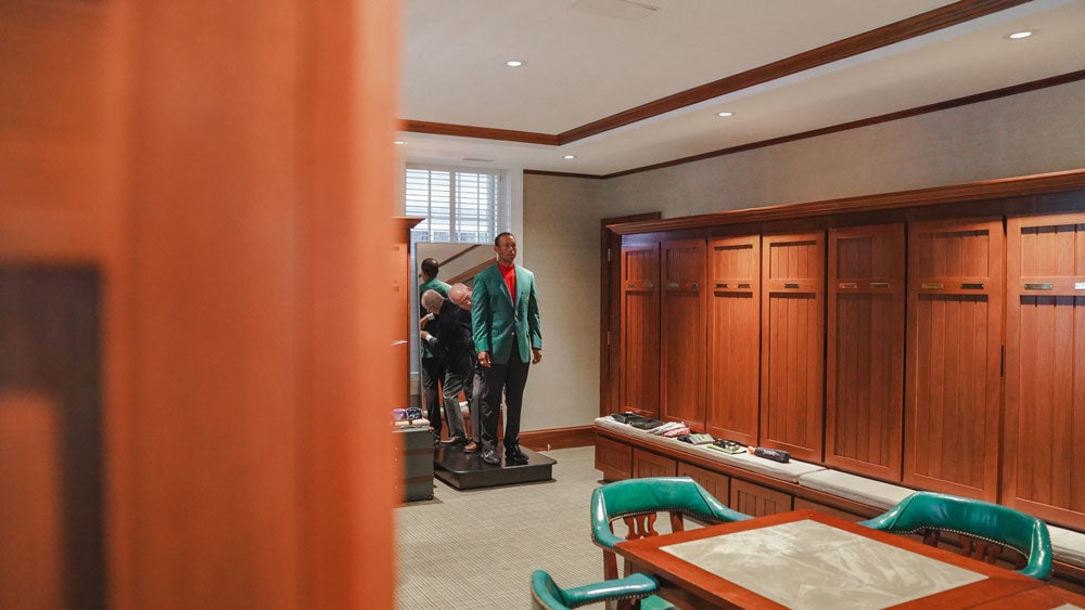 Tiger Woods gets fitted for his Masters green jacket in 2019.
