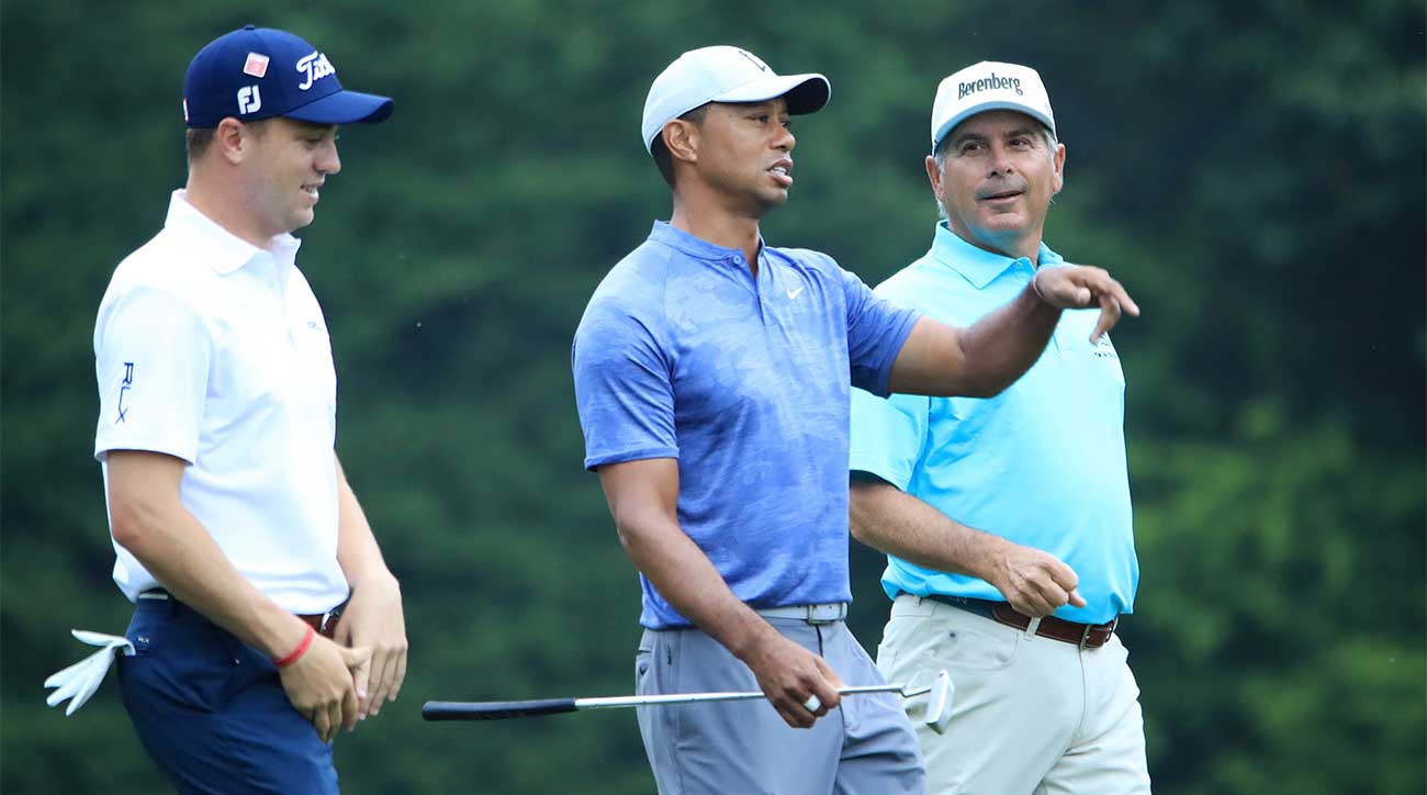 Tiger Woods walks with Fred Couples and Justin Thomas during a practice round at the 2019 Masters.