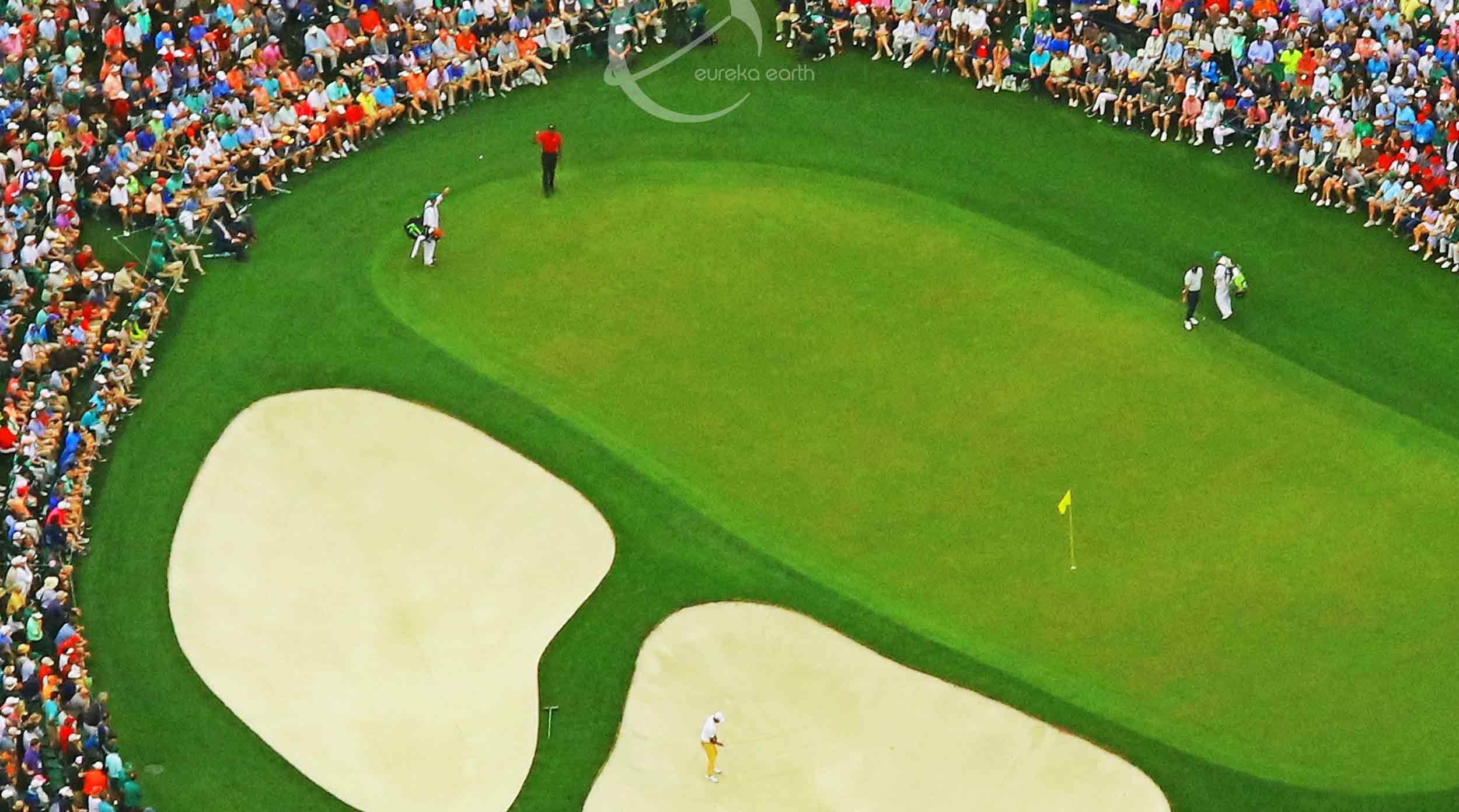 Tiger Woods on the 9th green, nine holes from victory. Woods' caddie, Joe LaCava, is flipping a ball to him.     
