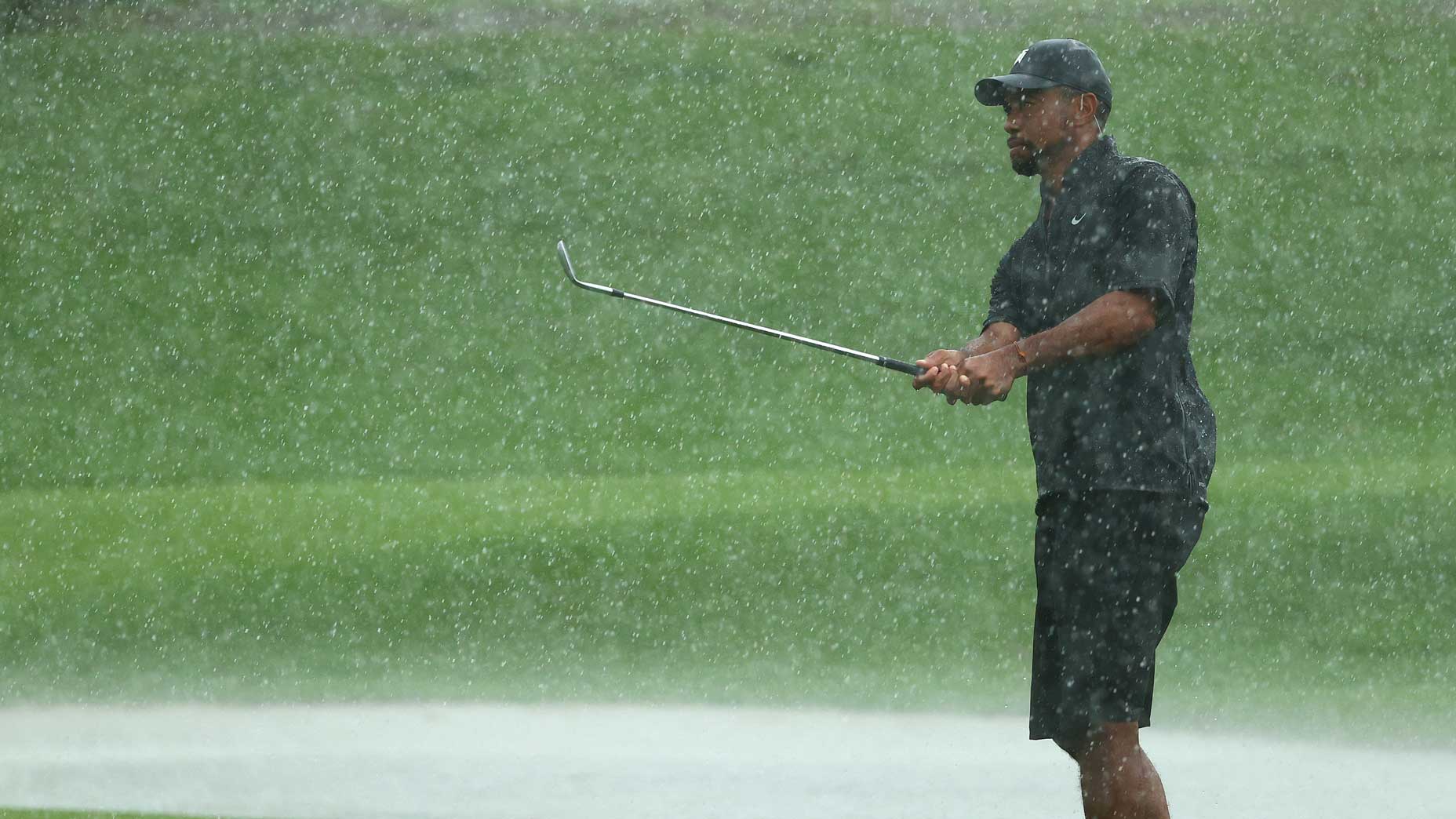 Tiger Woods warms up on the range at Medalist Golf Club.