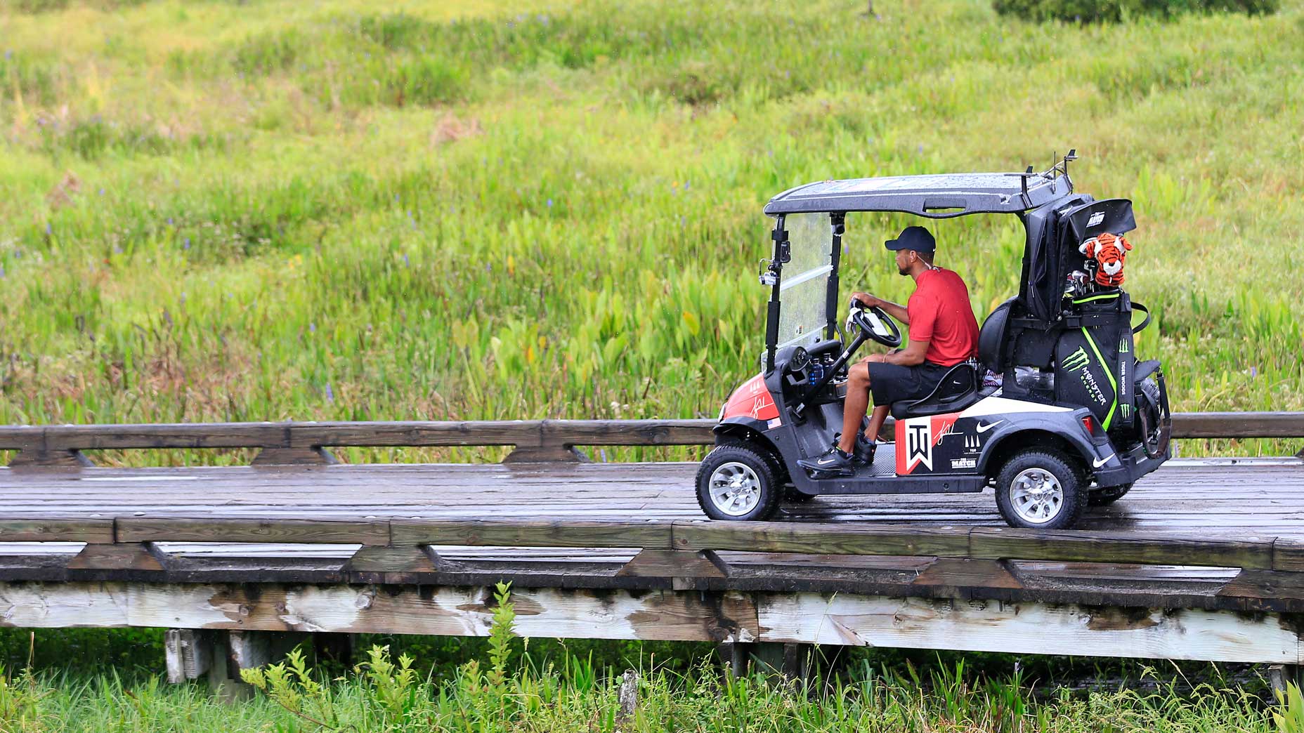 Tiger Woods drives to the 1st tee at Medalist Golf Club.