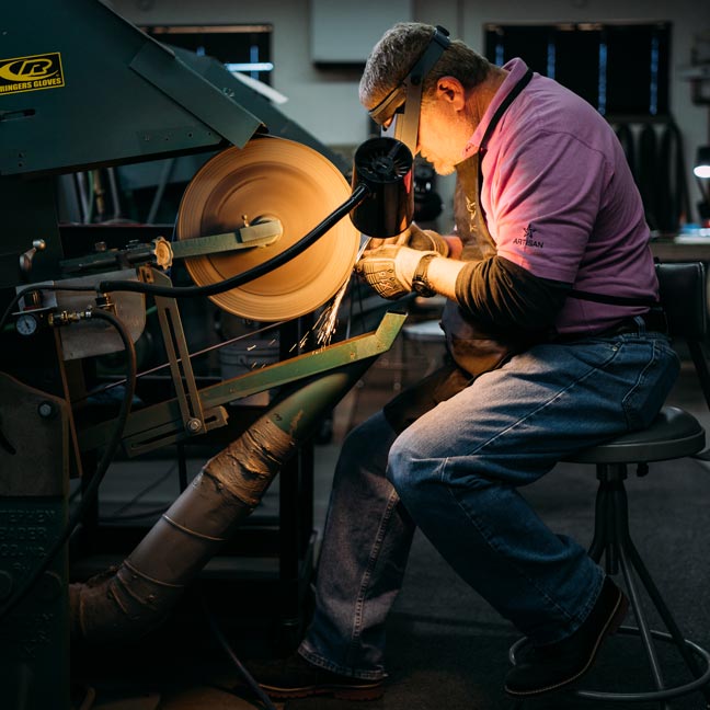 Mike Taylor grinds golf wedge.