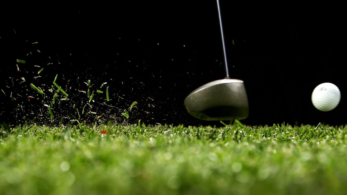 Driver hitting golf ball