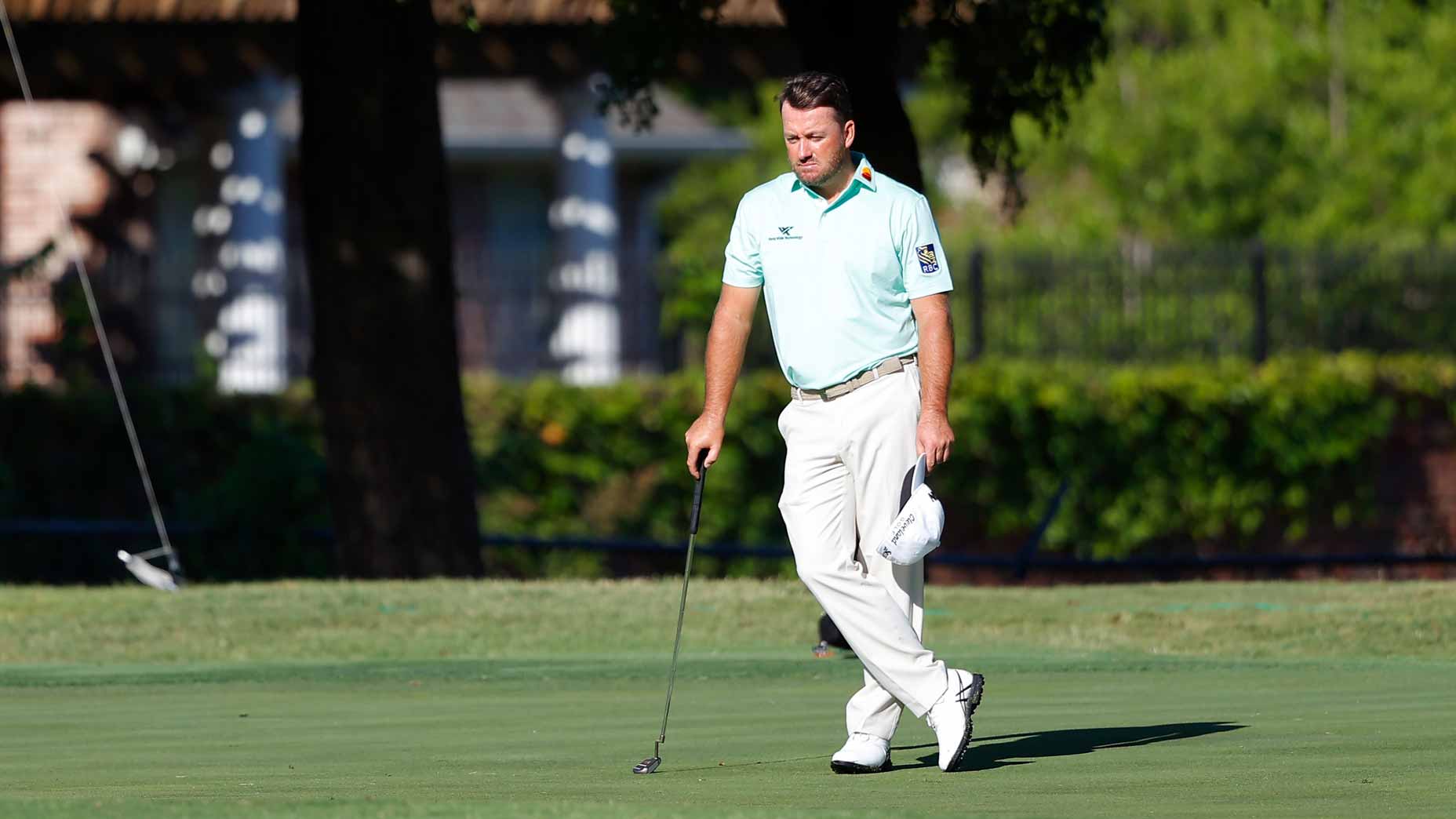 Pro golfer Graeme McDowell stand on golf course