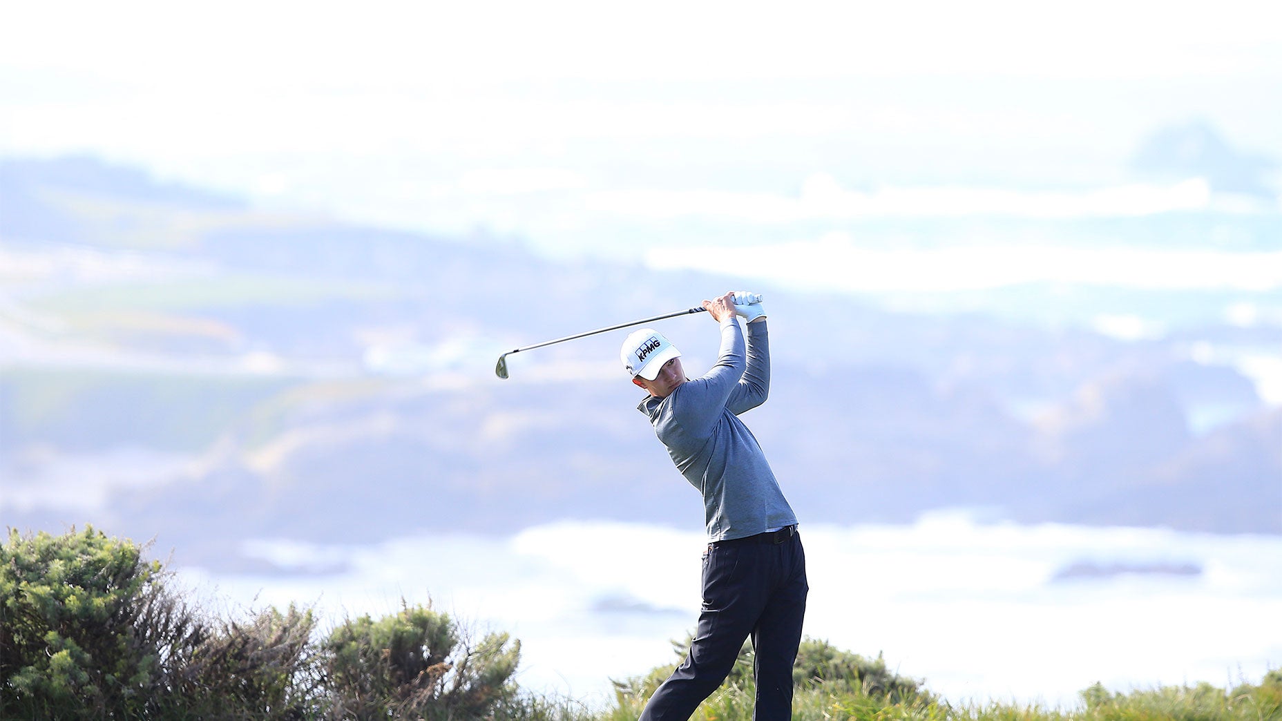 Maverick McNealy hits a shot at Pebble Beach.