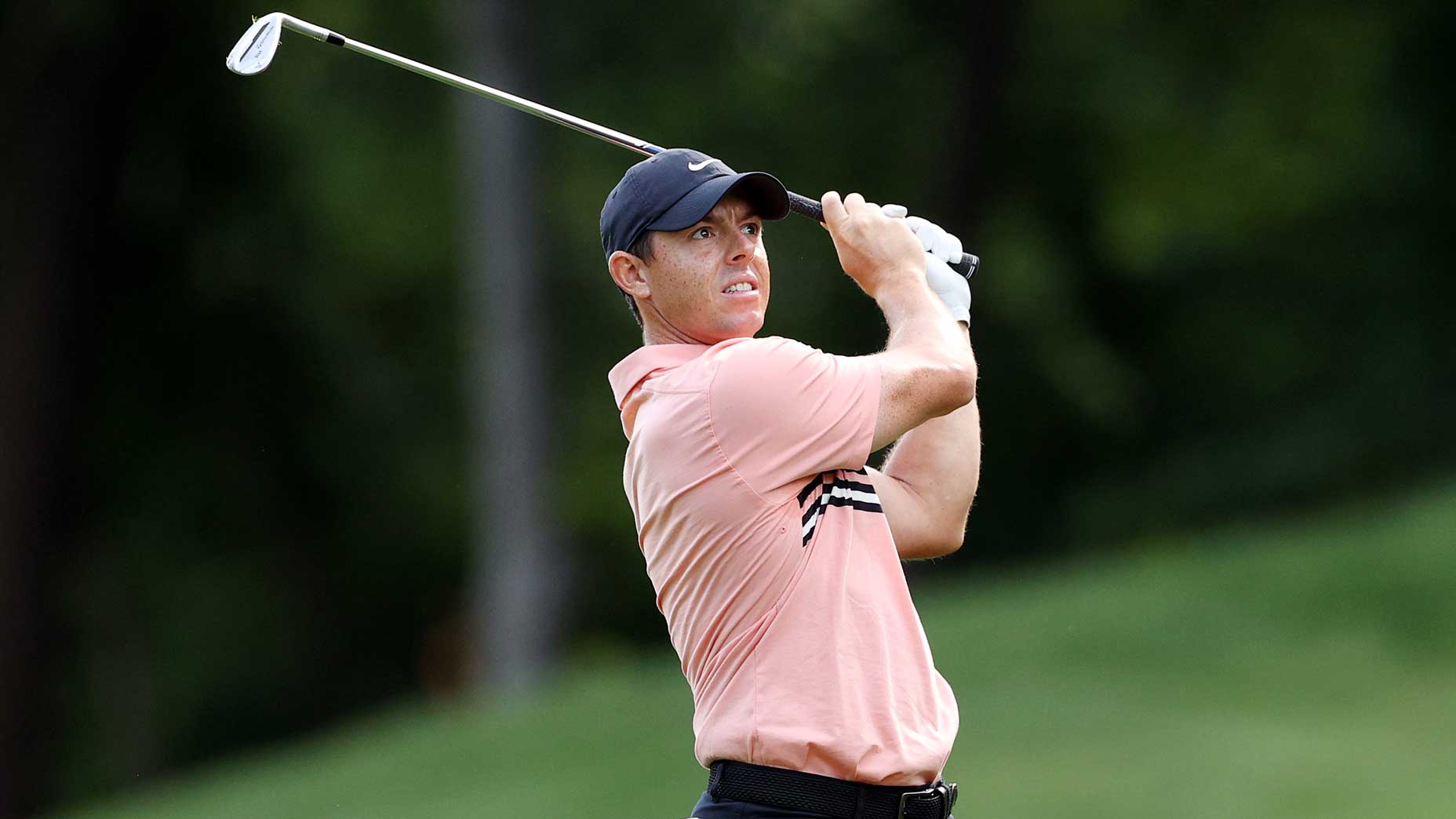 Pro golfer Rory McIlroy watches shot