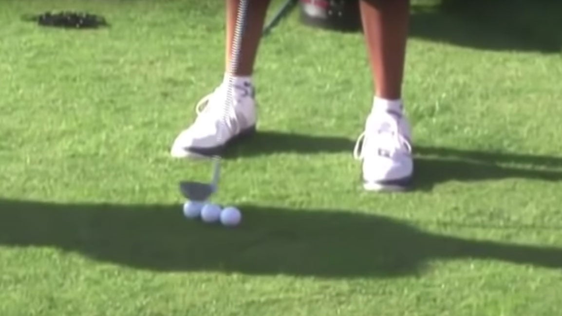 Tiger Woods' 5-iron goes a little further forward in his stance.