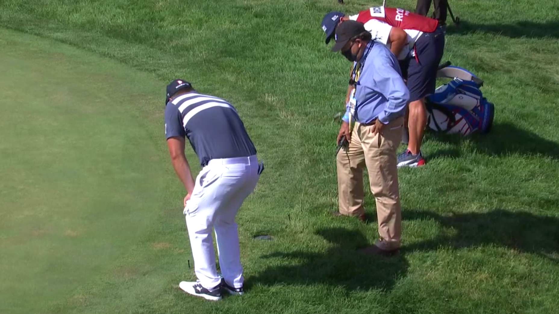 Bryson DeChambeau takes a drop at the Rocket Mortgage Classic.