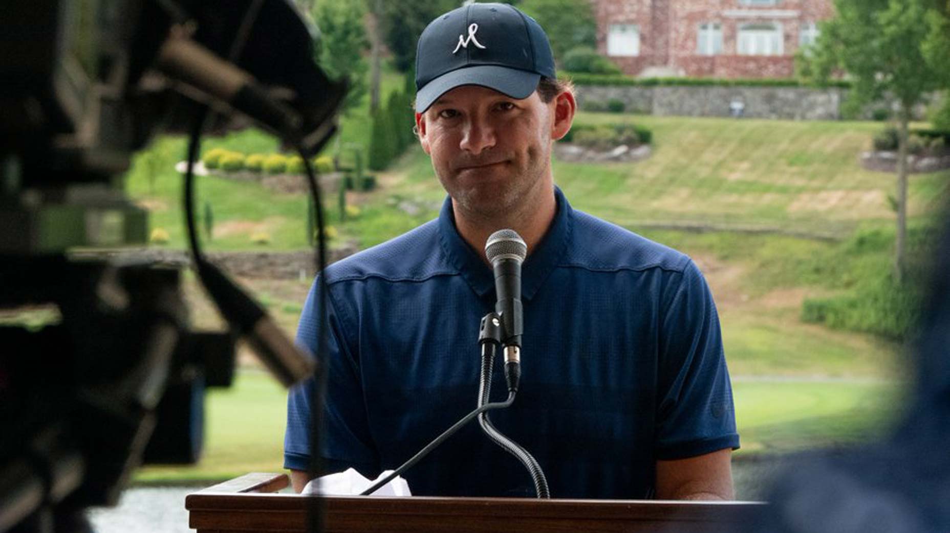 tony romo speaks at the podium