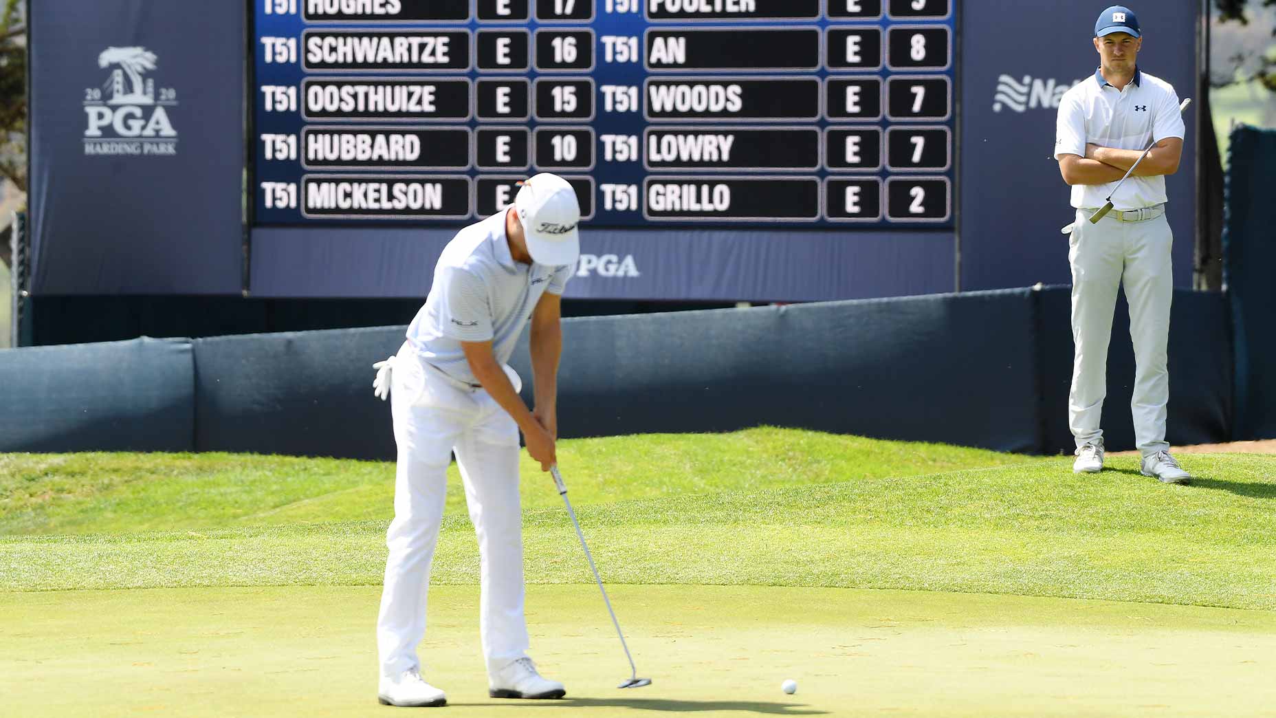 justin thomas putts with jordan spieth in background