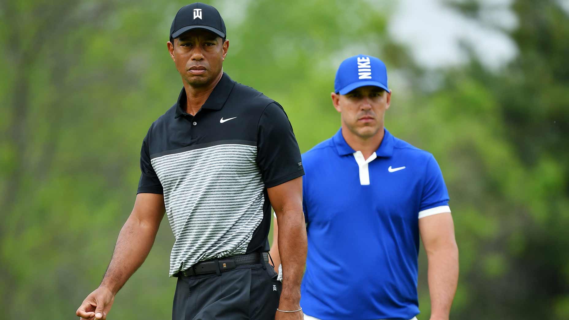 Golfers Tiger Woods and Brooks Koepka