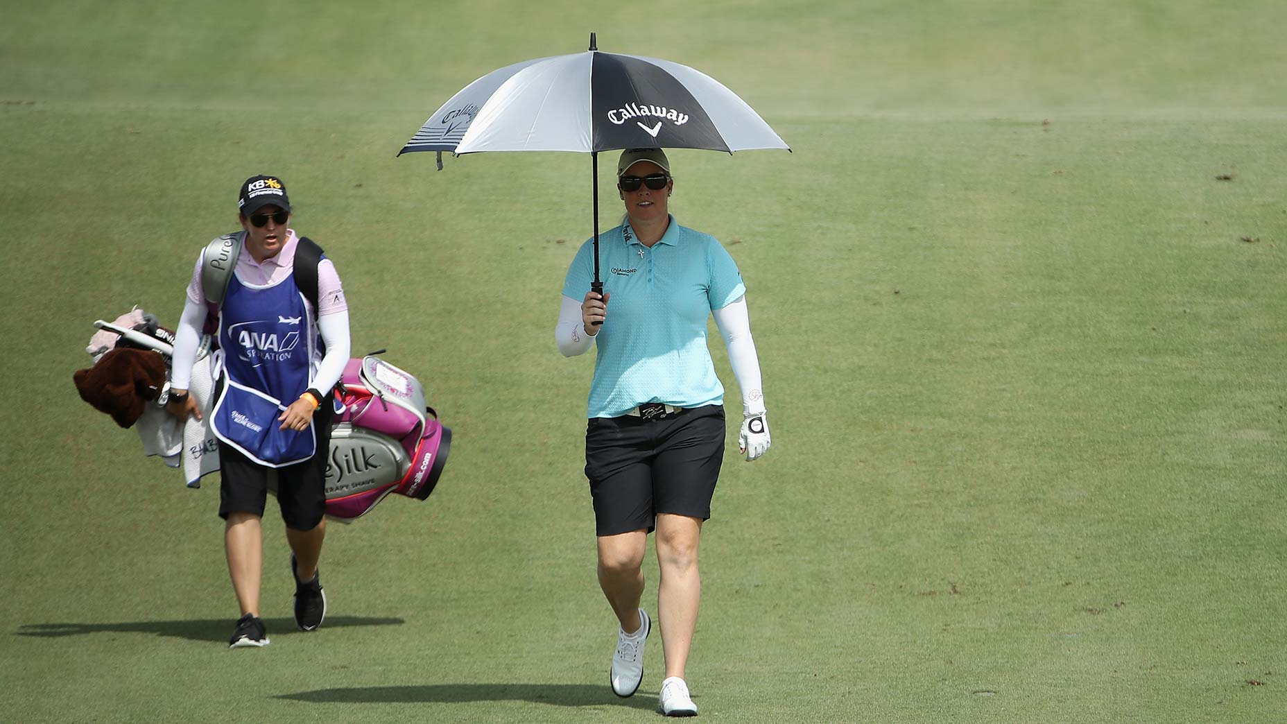 brittany lincicome walks with umbrella