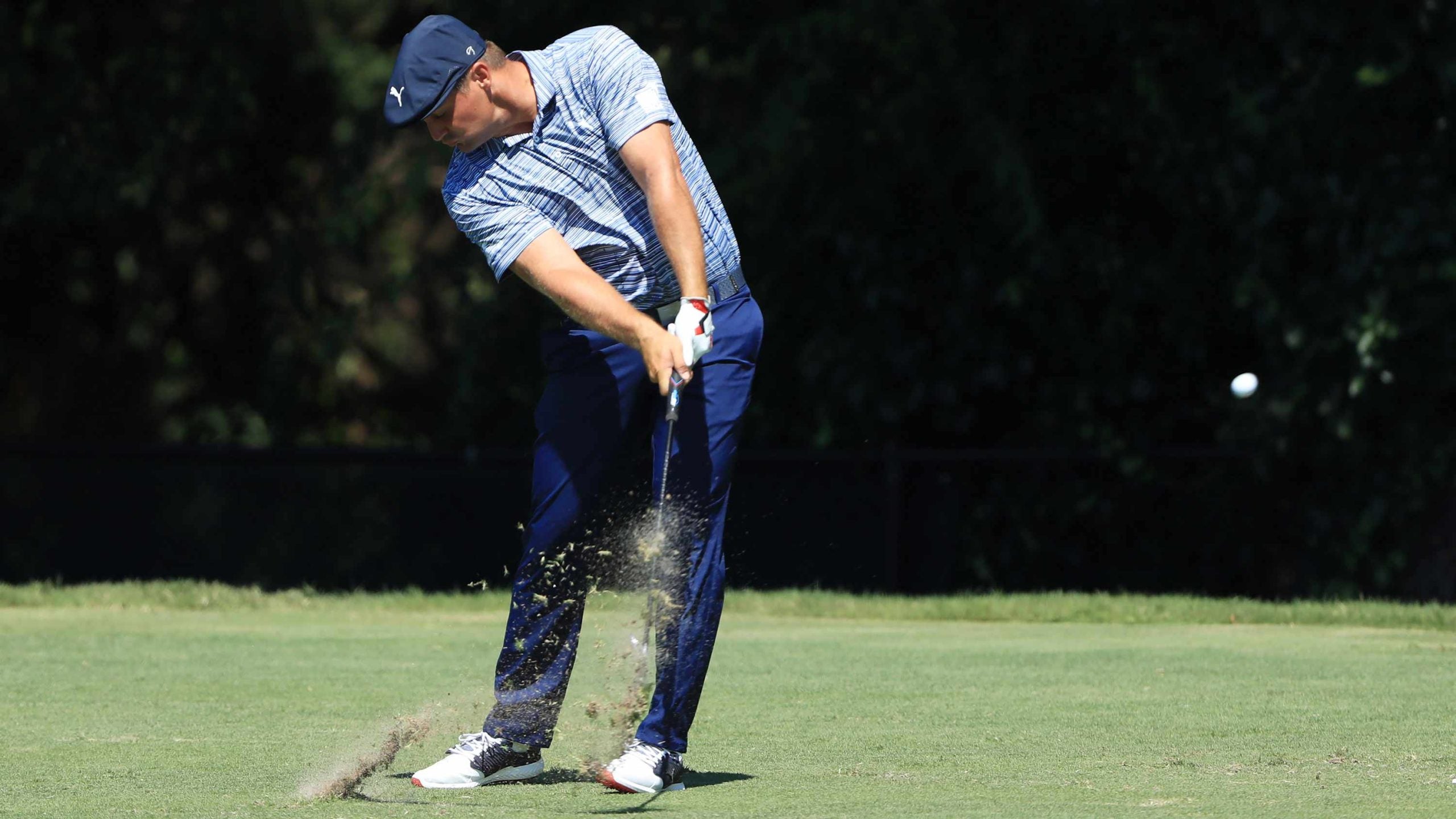 bryson dechambeau hits an iron