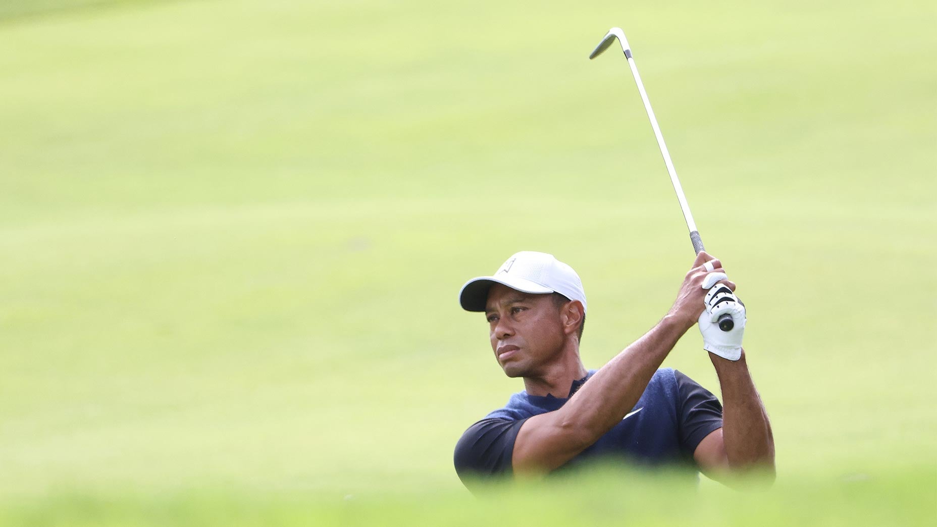 Tiger Woods takes a swing at Winged Foot.