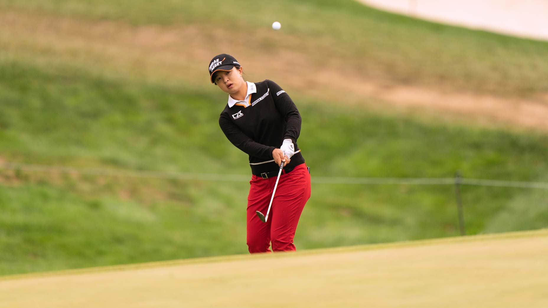woman hits chip shot