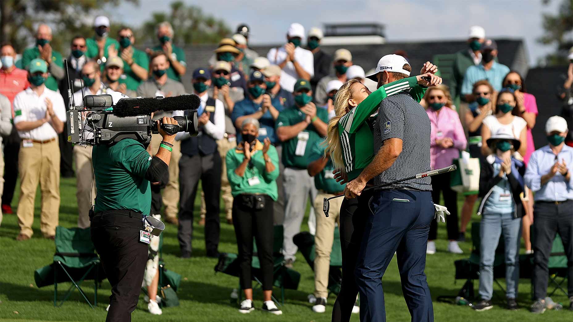 Dustin Johnson and Paulina Gretzky hug.