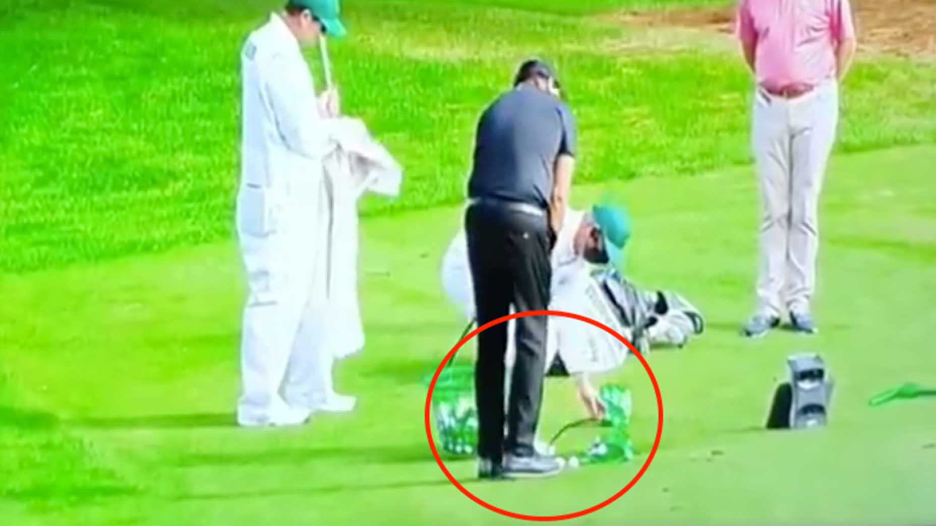 Phil Mickelson chips at the practice area at Augusta National.