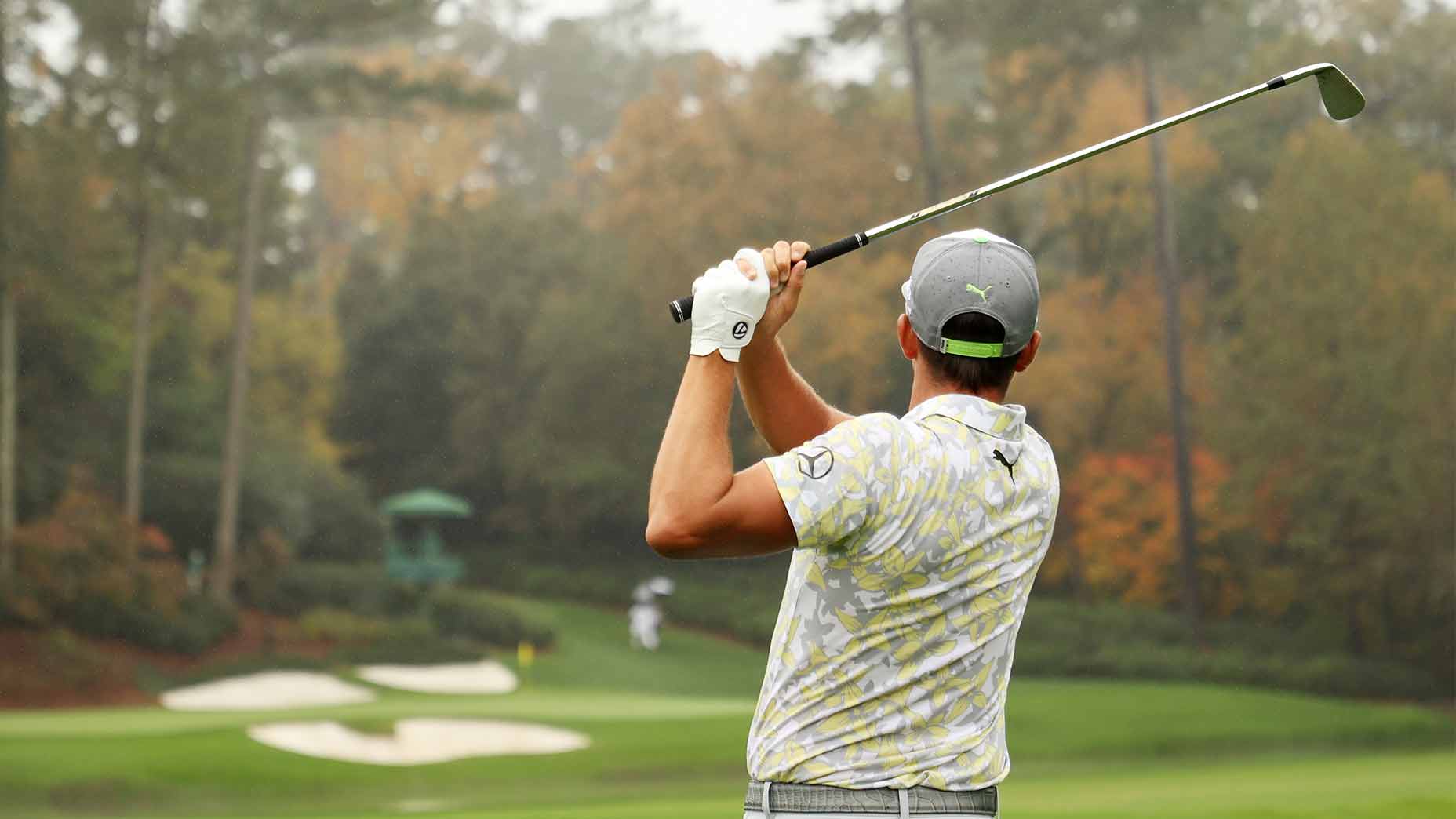 Rickie Fowler hits a tee shot at the Masters.