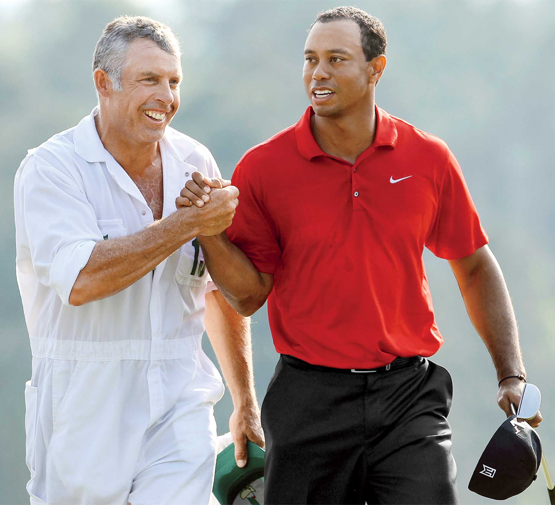 Tiger Woods and Steve Willilams walk off the 18th green at the 2011 Masters.