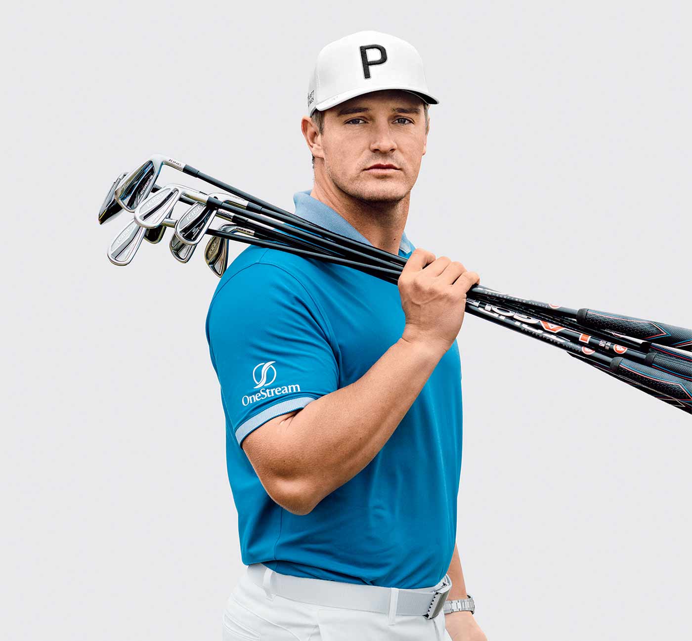 Bryson DeChambeau holds golf clubs.