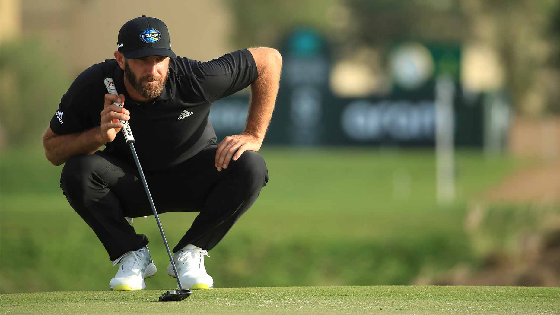Dustin Johnson reads a putt.