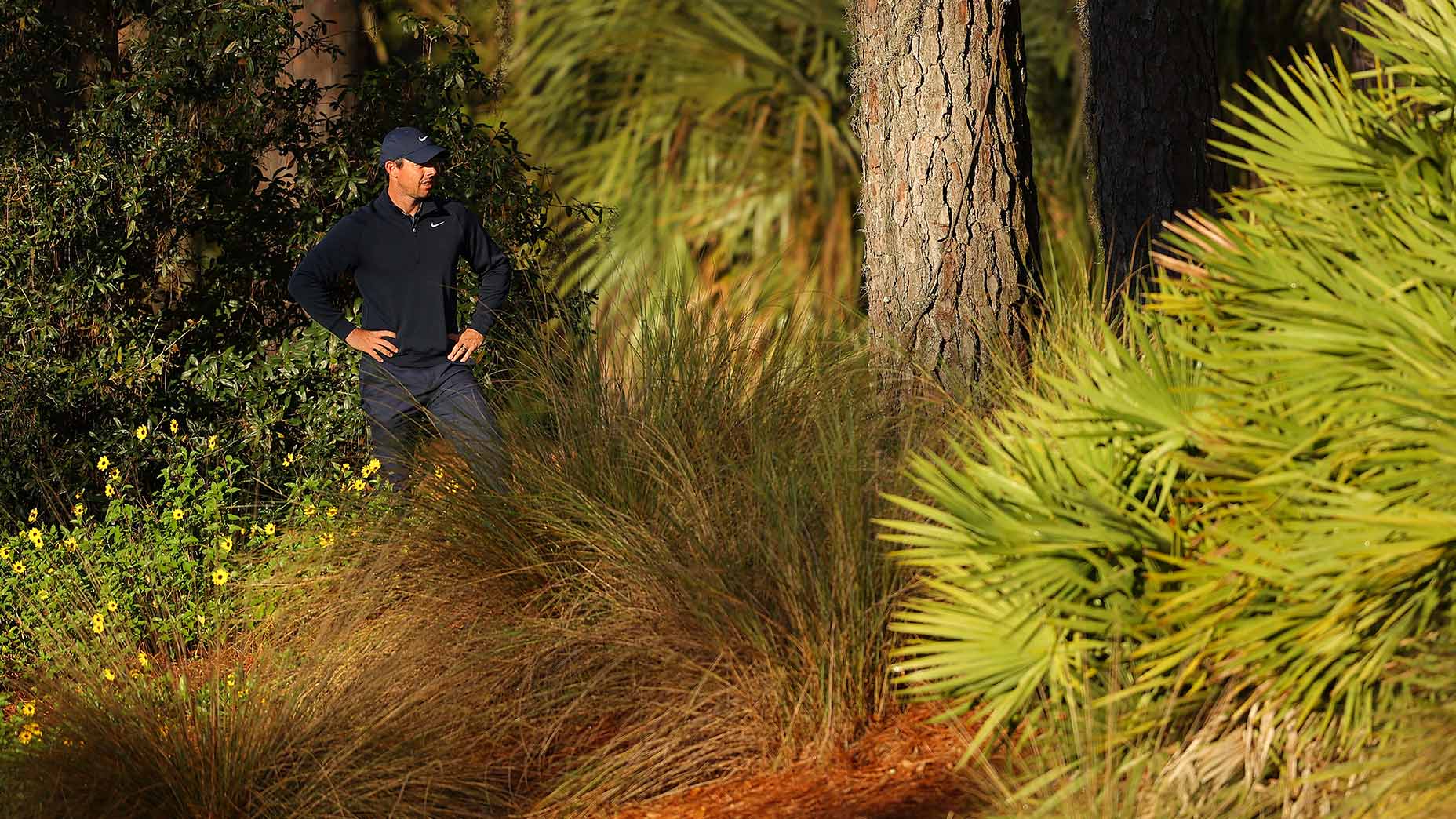 Rory McIlroy looks for his ball off the 10th fairway on Thursday.
