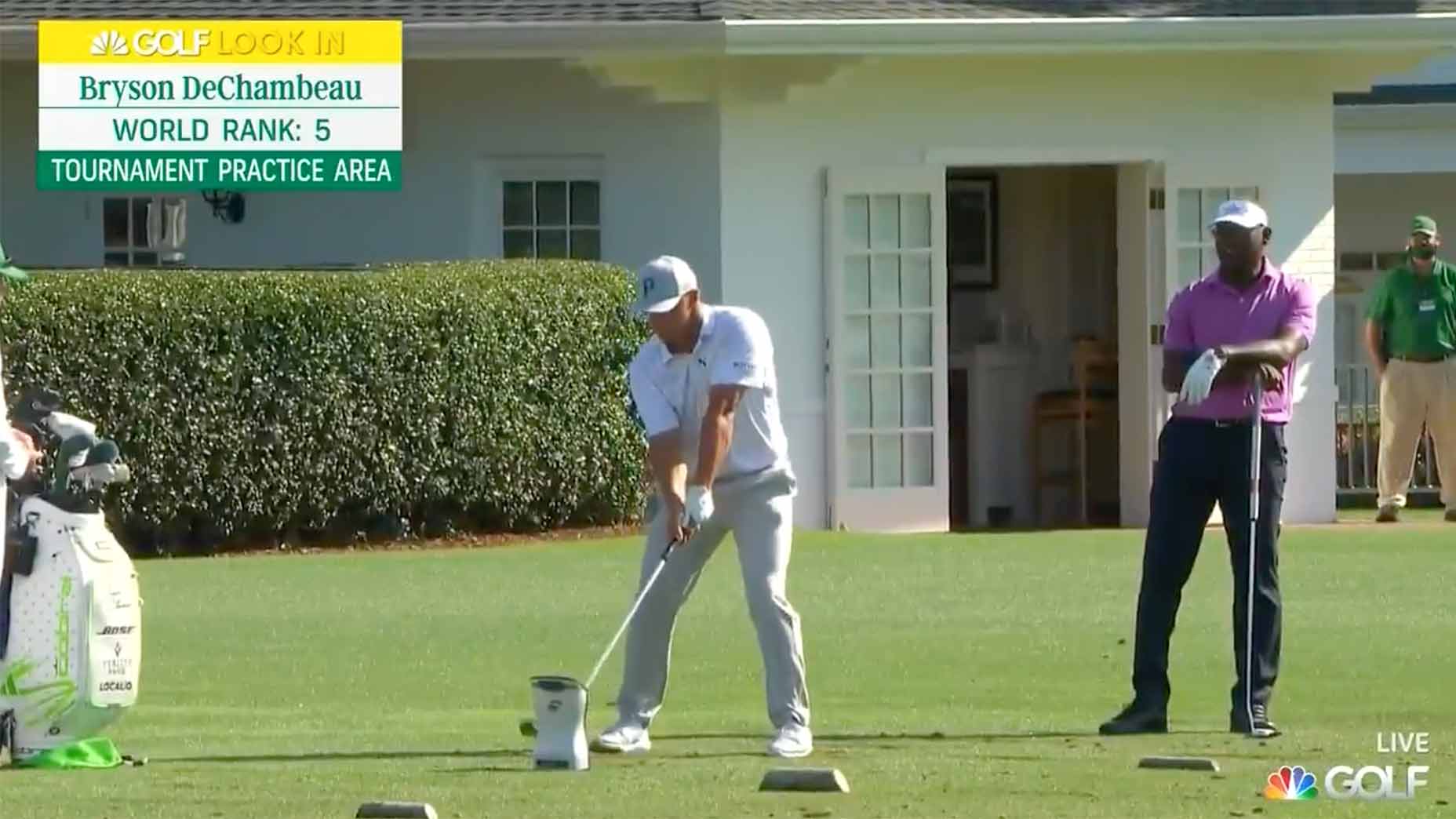 Vijay Singh watches Bryson DeChambeau hit drivers on Monday at the Masters.