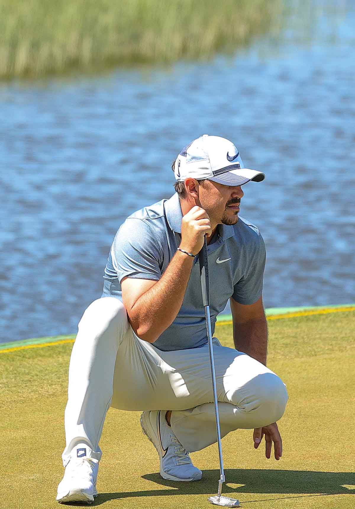 brooks koepka reads a putt