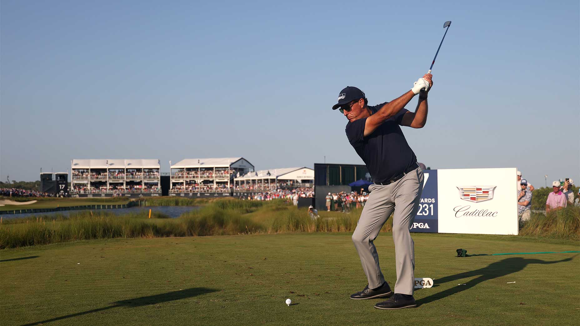 phil mickelson swings a golf club.