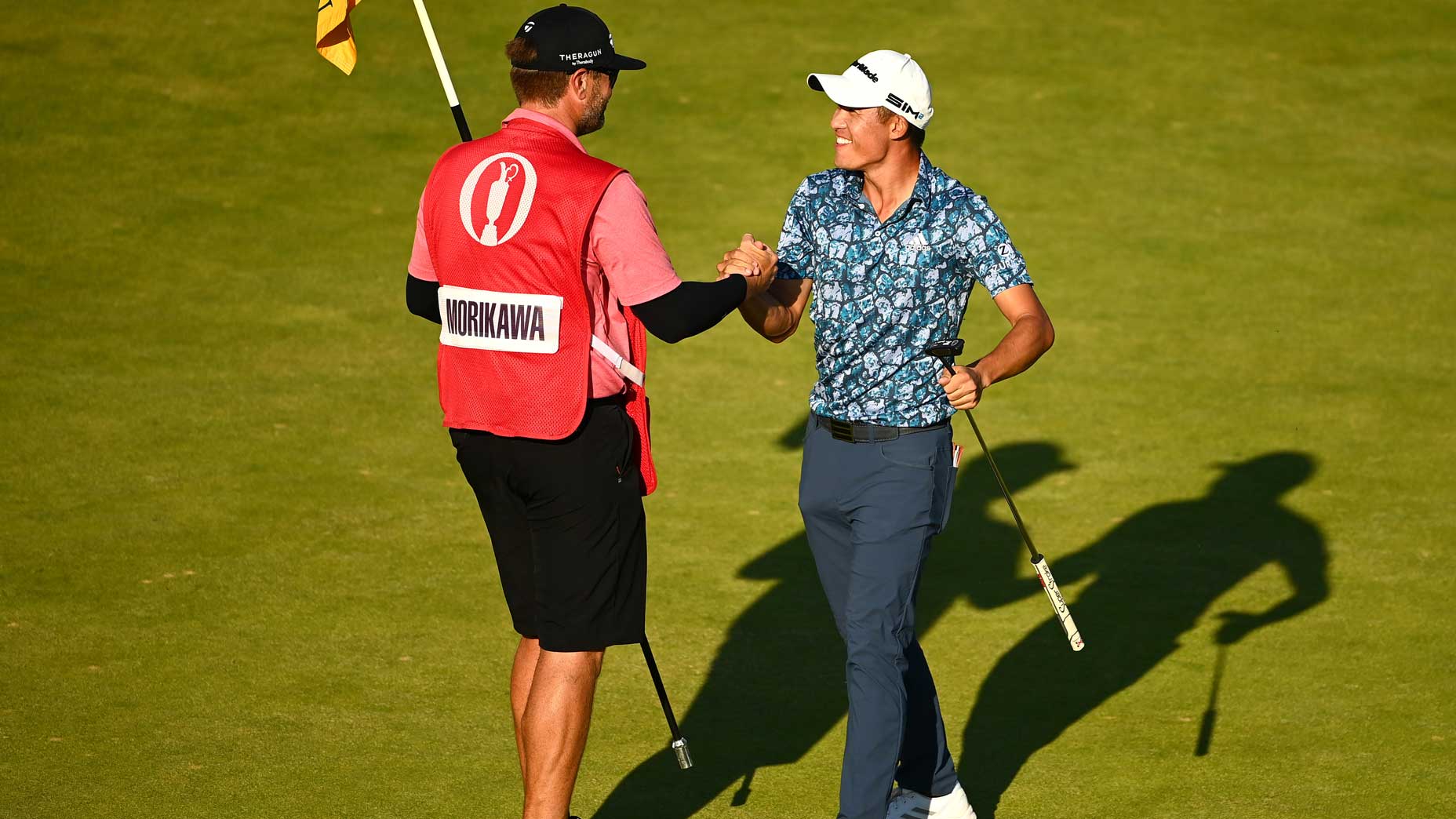 collin morikawa and caddie embrace
