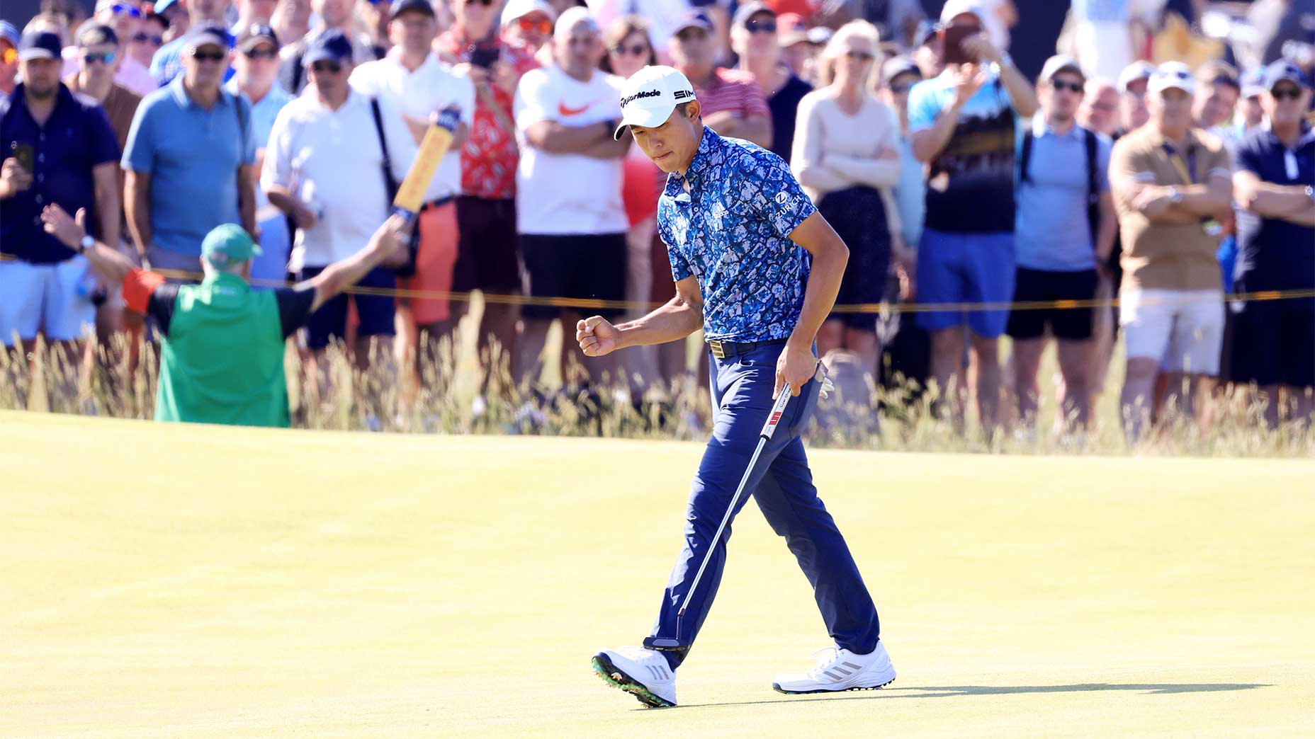 Collin Morikawa walks in a putt at the 2021 british open.