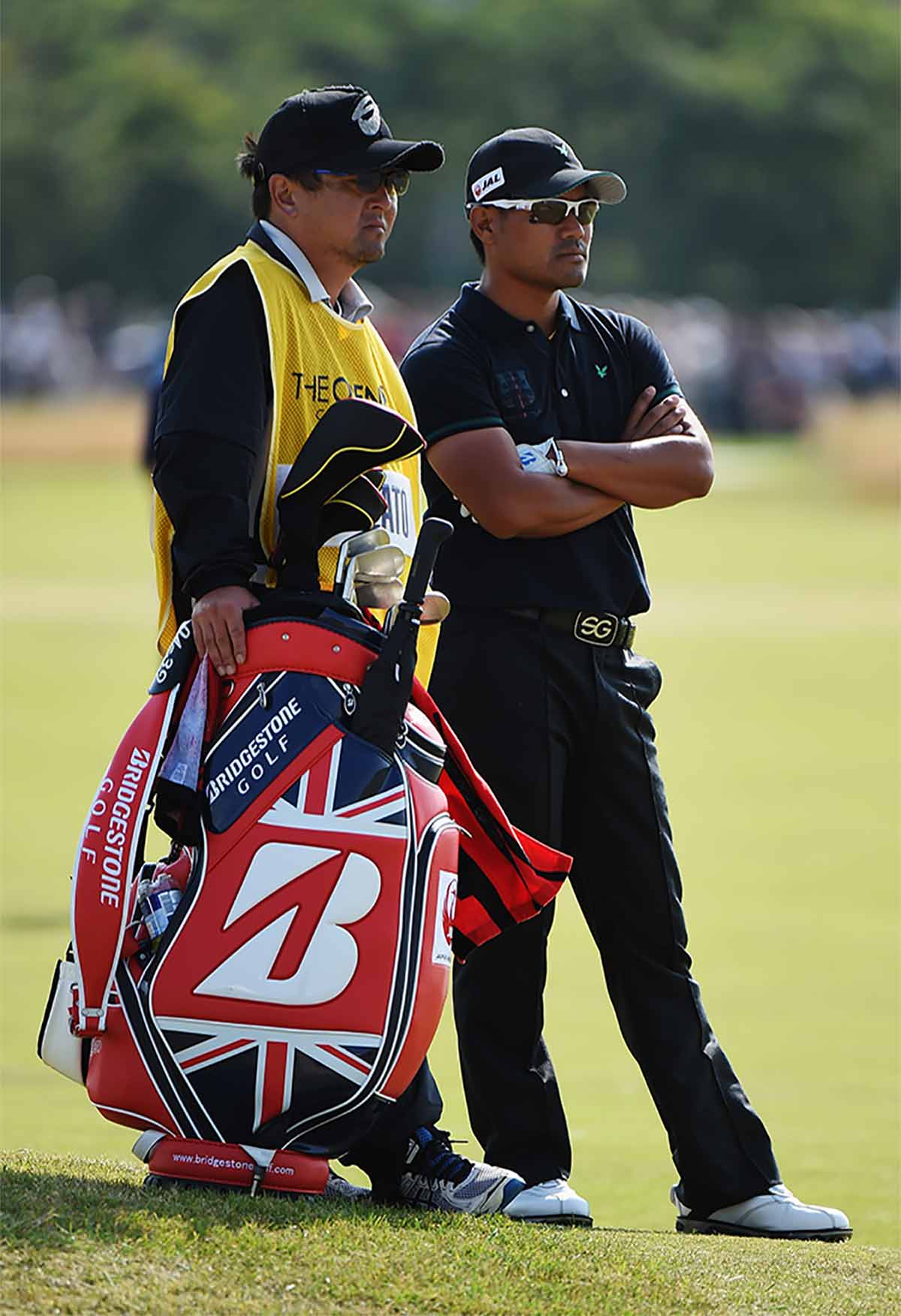 Nobuaki Sugisawa (left) caddying for Yusaku Miyazato at the 2014 Open Championship.