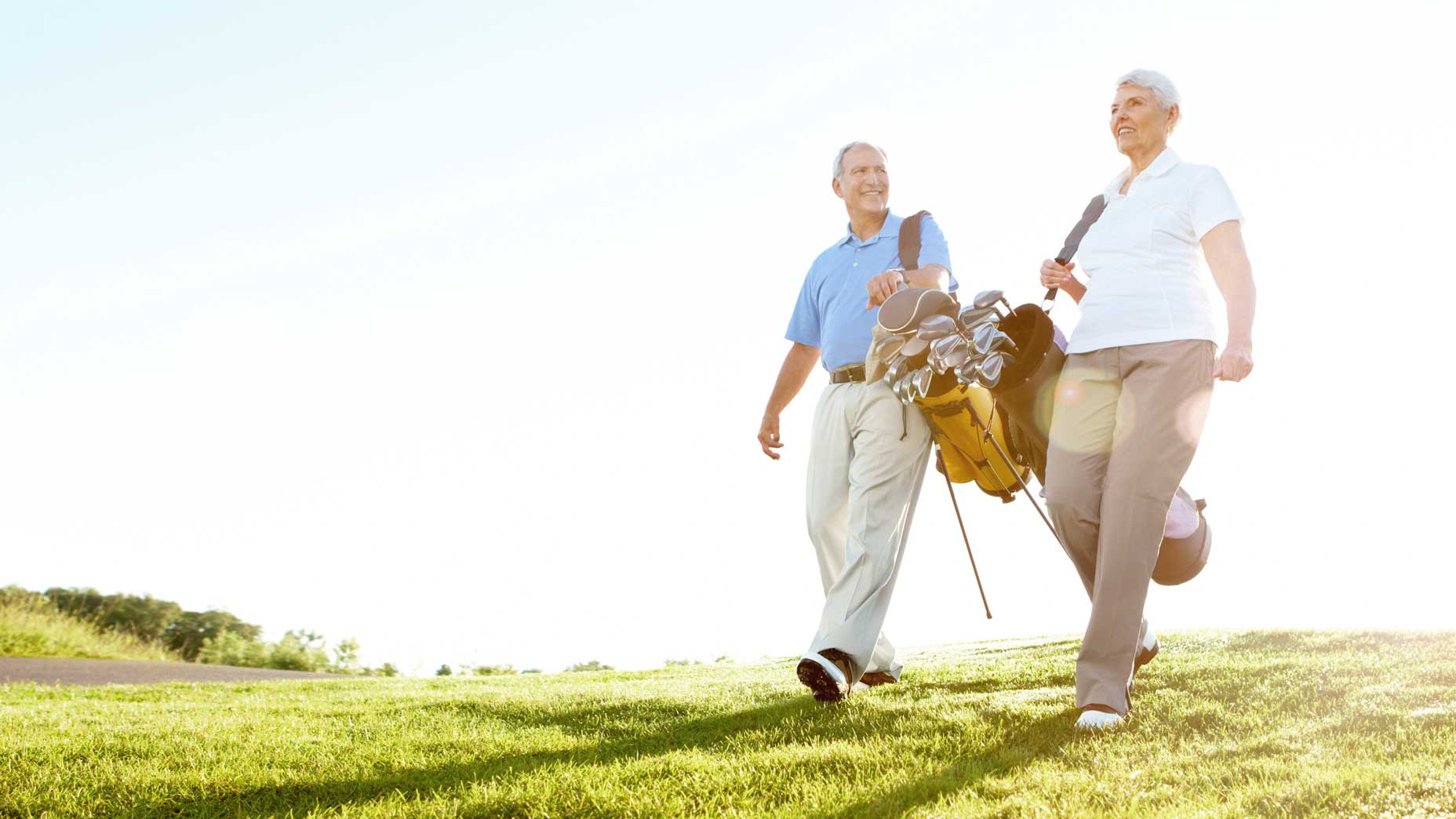 old golfers walk the fairway