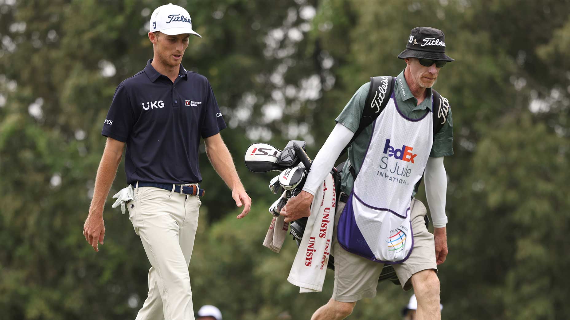 Will Zalatoris and his caddie walk down the fairway.