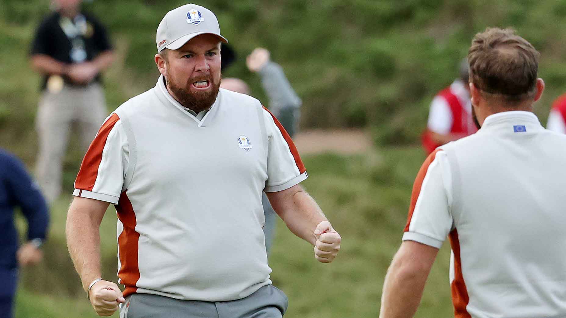 Shane Lowry grimaces in celebration facing partner Tyrrell Hatton at the 2021 Ryder Cup.