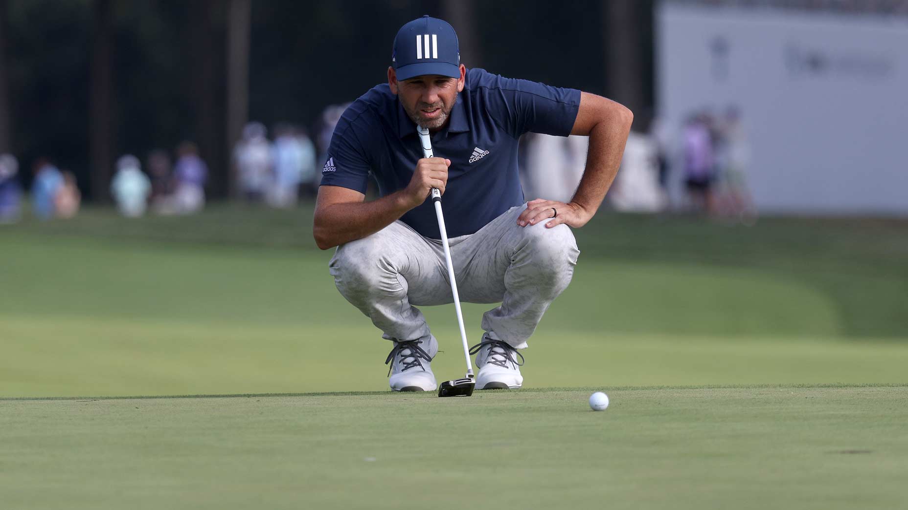 Sergio Garcia on putting green to read putt during 2021 BMW Championship
